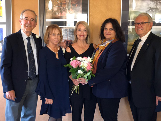 Carlsbad artist Rita Shulak, shown here with Phyllis and Mayor Hall, and Tonya and Tom Hersant holds flowers given her. 
