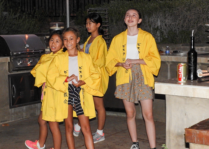 CSCA director Bill IIshi directed his troupe in song and dance entertainment.