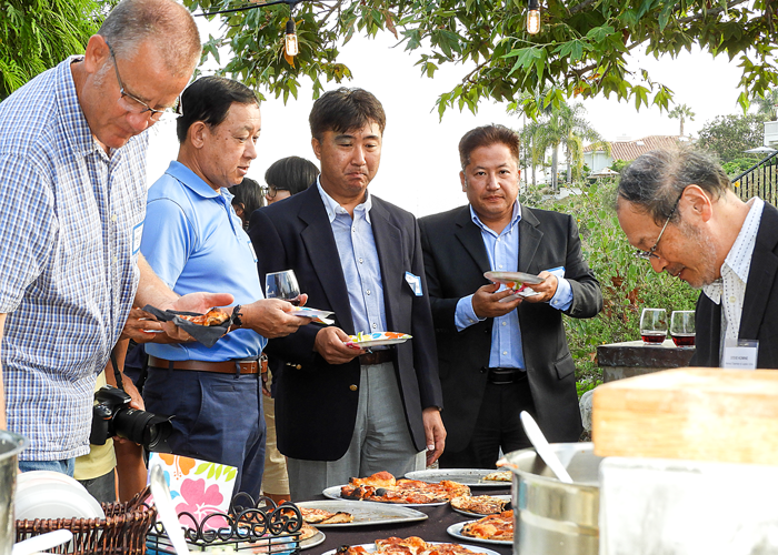 Futtsu delegates sampling Peder's wood-fired pizza. 