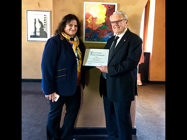 Mayor Hall presenting the City of Carlsbad’s Certificate of Recognition to Rita Shulak.